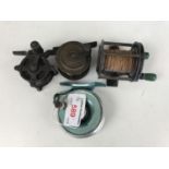 Four small fishing reels including The Peerless Profile, Multiplier and two others