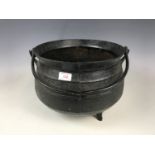 An antique cast iron cauldron