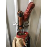 A vintage golf bag together with Golfco and Championship clubs