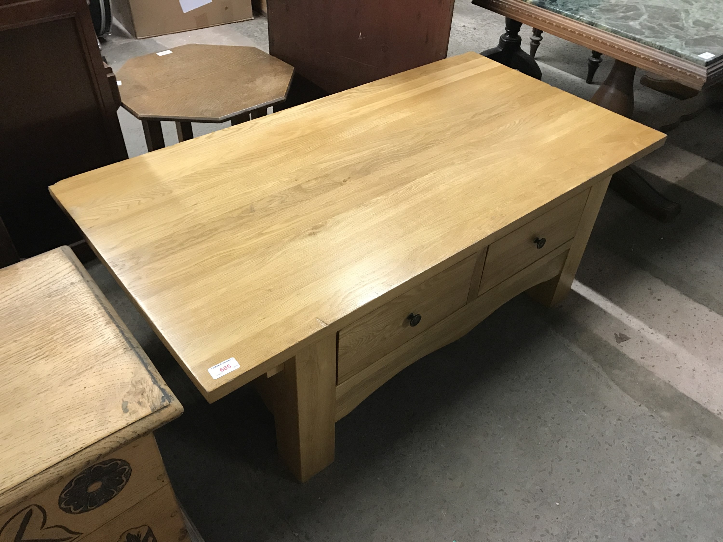 A contemporary light oak coffee table