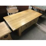 A contemporary light oak coffee table