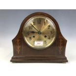 A brass-faced mahogany mantle clock