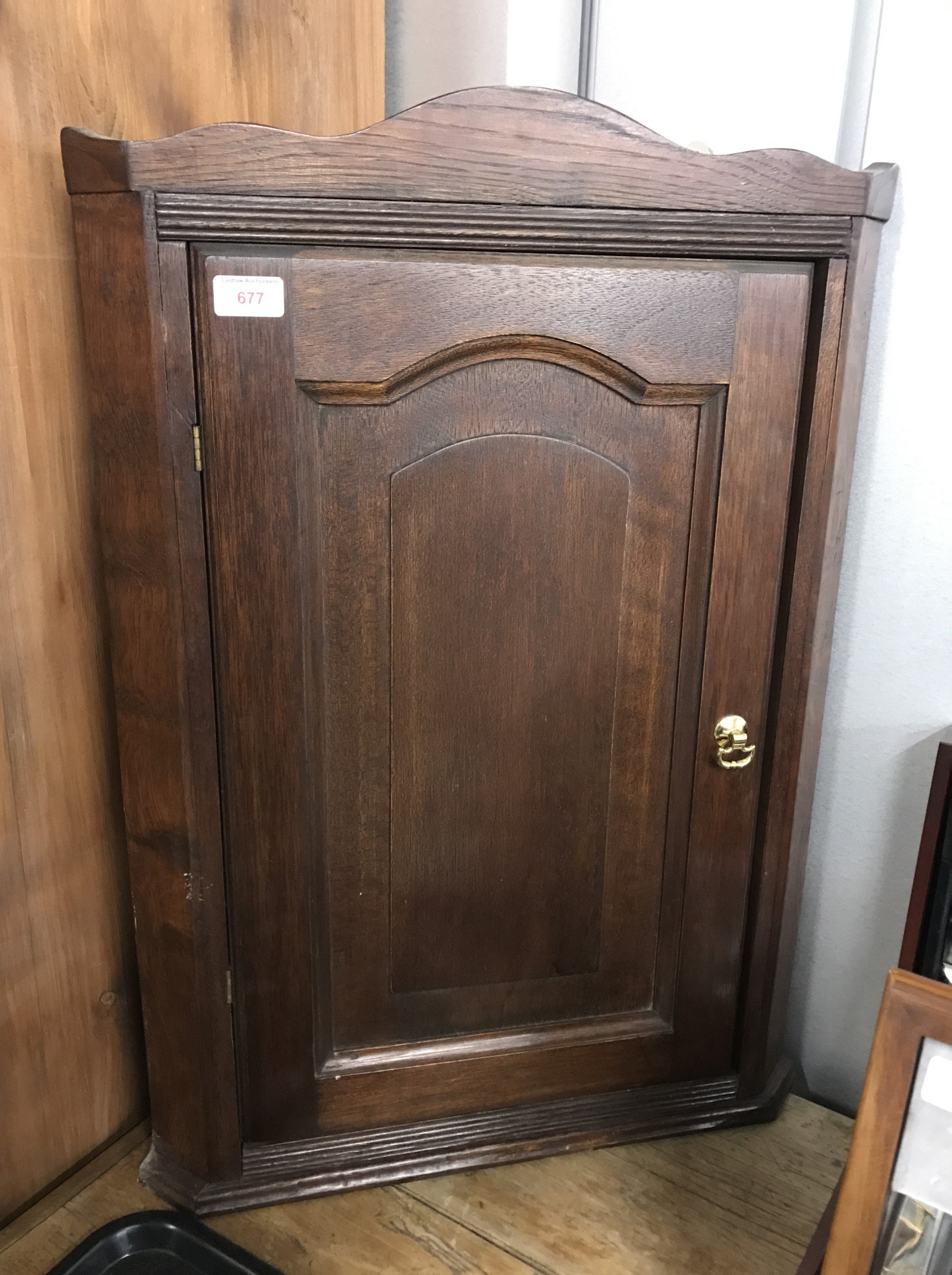 A reproduction Victorian oak hanging corner cabinet