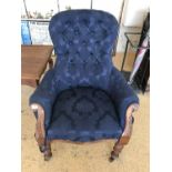 A Victorian carved and upholstered oak easy arm chair