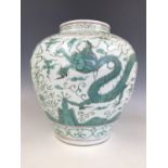 A large Chinese porcelain green enamelled vase, of shouldered ovoid form decorated in depiction of