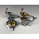 A vintage AA car badge together with two cast peacocks and a camel