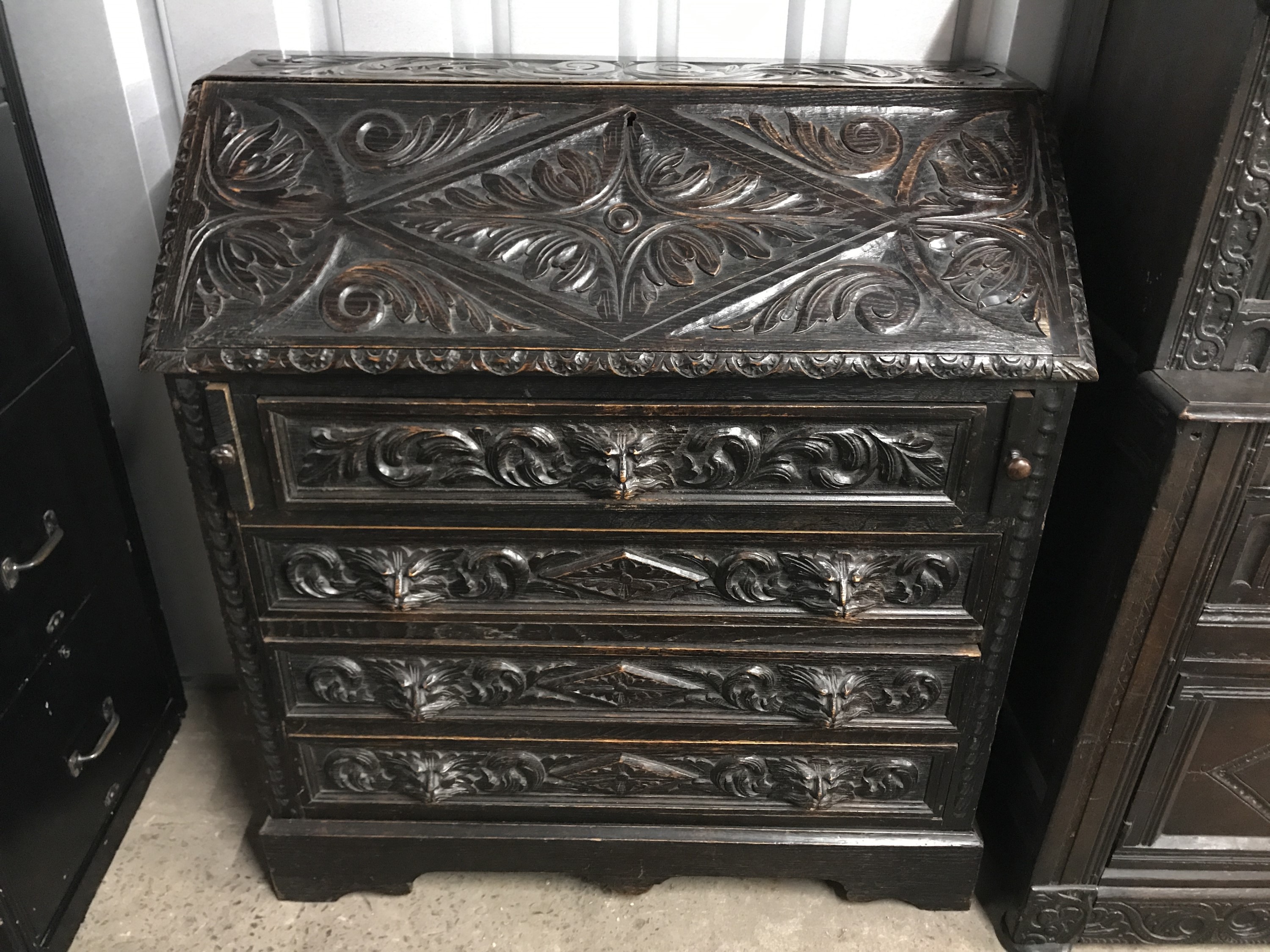 A late 19th century Flemish style carved fall front bureau