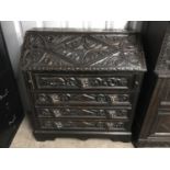 A late 19th century Flemish style carved fall front bureau