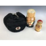A Glasnost period caricature Russian Marushka doll together with one other and a Soviet fur hat