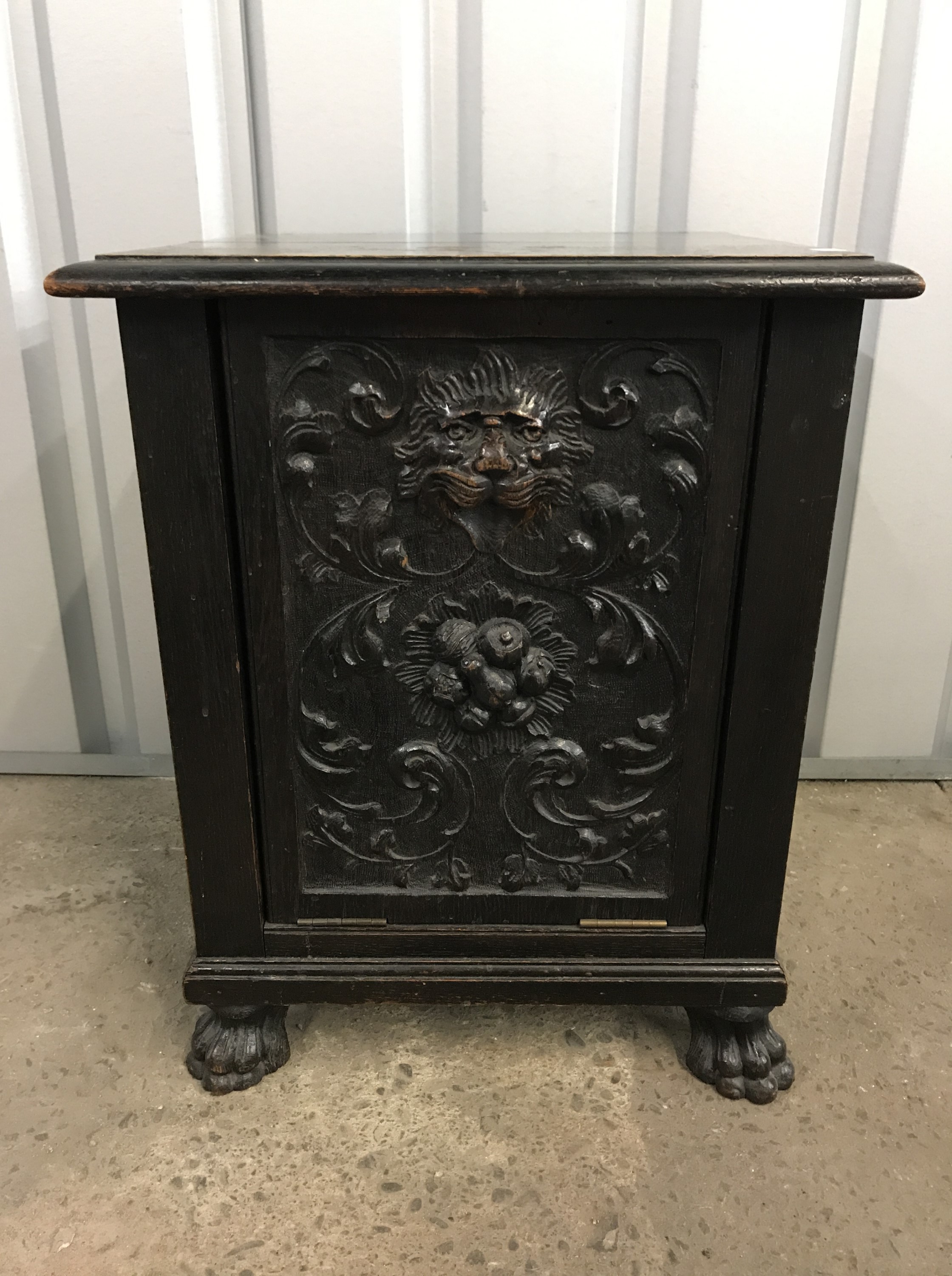 A late 19th century Flemish style carved oak coal purdonium