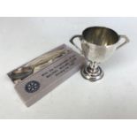 A small silver trophy cup together with a boxed 1937 commemorative silver spoon