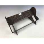 A diminutive carved oak book trough