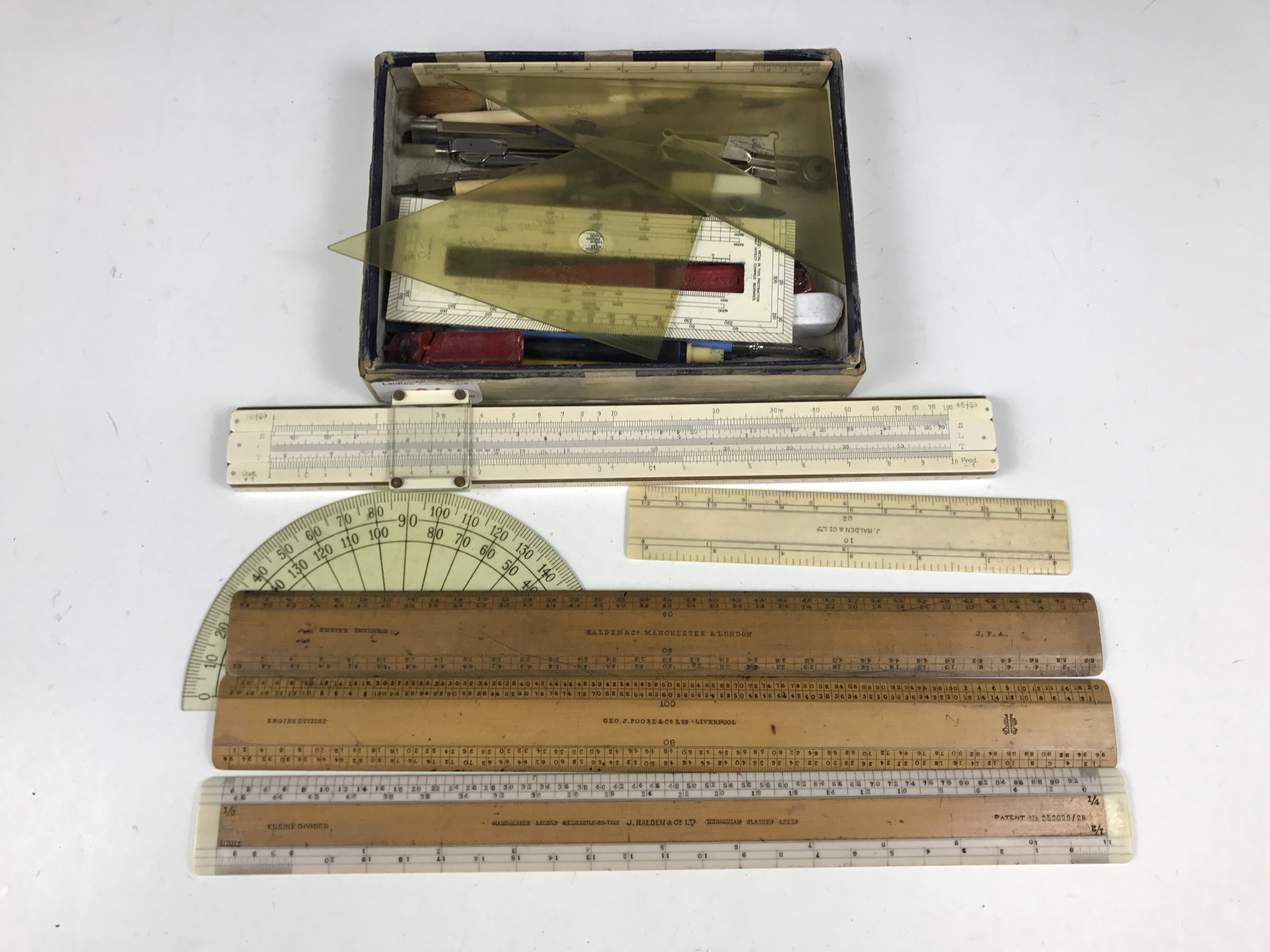 A quantity of vintage writing and drawing instruments together with rulers etc.