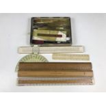 A quantity of vintage writing and drawing instruments together with rulers etc.