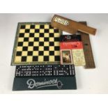 Two vintage dominoes sets together with playing cards, a cribbage board etc.