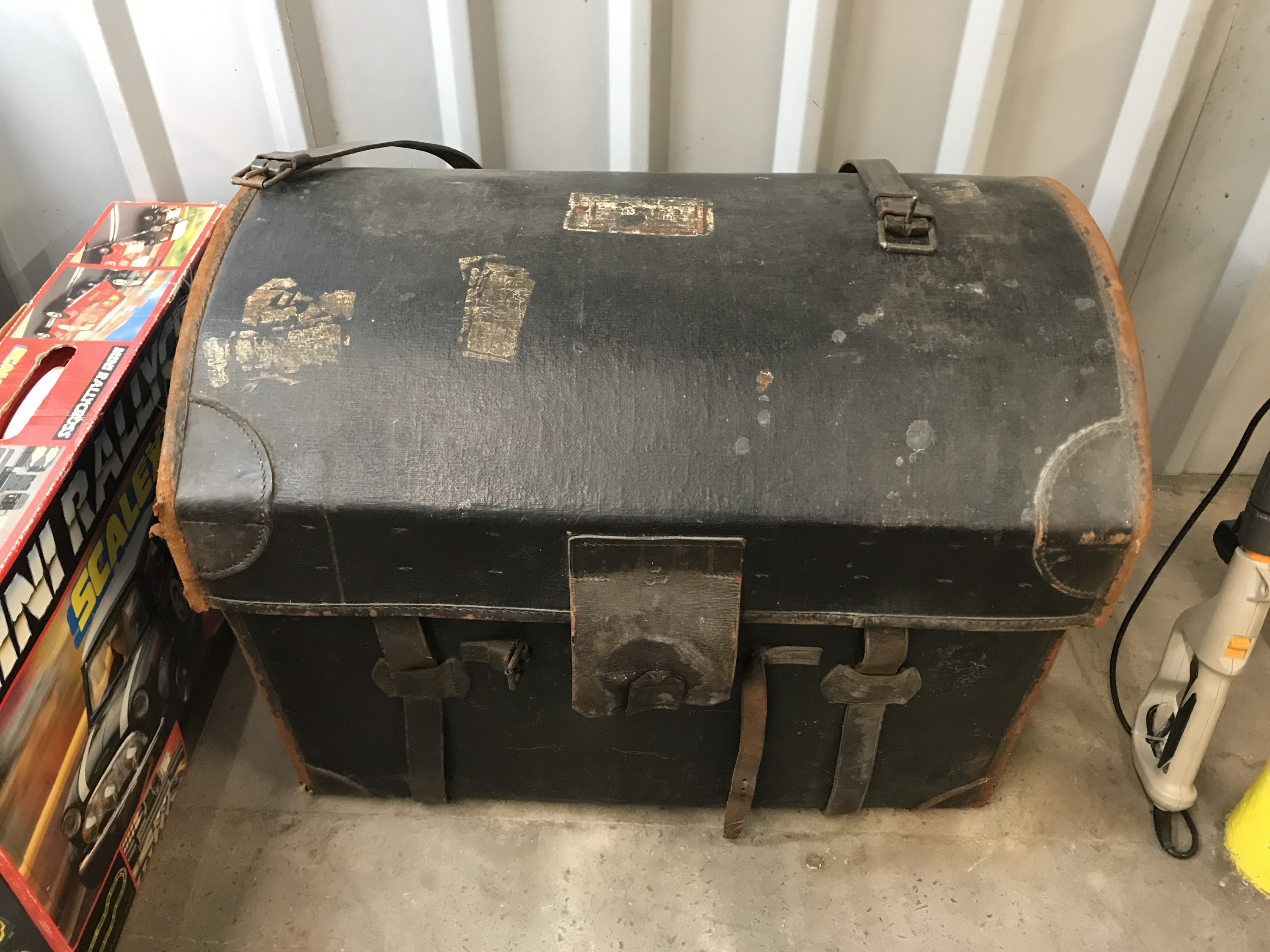 A Victorian leather-trimmed and Japanned canvas covered wicker travel trunk, with inner tray, the