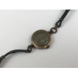 A lady's vintage gold-cased wristlet watch