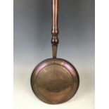An early 19th century copper bed warmer