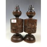 A pair of oriental carved wood table lamp bases