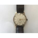 A 1950s gentleman's 9ct gold cased wrist watch, having a Smiths 15-jewel crown-wound movement,