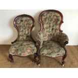 A pair of Victorian upholstered and carved mahogany easy chairs