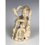 A Japanese carved marine ivory okimono depicting a bijin sat holding a fan, mid 20th Century, 11 cm