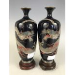 A pair of Meiji Japanese cloisonné vases, each finely decorated in depiction of a writhing dragon,