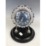 A Russian Art Deco adjustable mantle clock by Masaik, having teal enamelled face, silvered