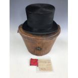 A 19th Century gentleman's black silk top hat manufactured by Tress & Co of London, in a leather hat