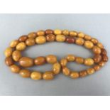 A vintage butterscotch amber necklace, having a single strand of graded oval beads, 61.2g