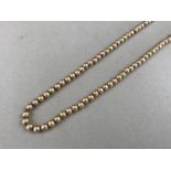 A vintage yellow-metal necklace, in the form of a fine belcher-link neck chain threaded with