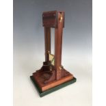 A table cigar cutter modelled as a guillotine, late 20th Century, 34 cm