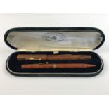 A 1920s Waterman's Ideal "woodgrain" combination writing set, comprising fountain pen and pencil,