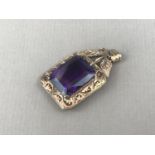 An amethyst and high-carat yellow-metal pendant, the faceted stone of approximately 17 x 14 mm, claw