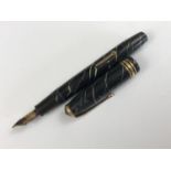 A 1950s Conway Stewart No.58 "cracked ice" fountain pen, in black and green celluloid, with 14ct