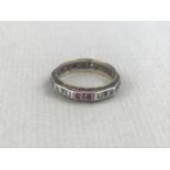 A vintage diamond and ruby eternity ring, of decagonal section, the faces alternately claw-set