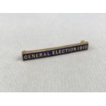 A "General Election 1910" rolled-gold and enamelled bar brooch, manufactured by Wolewis of