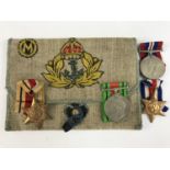 A Second World War Royal Navy campaign medal group together with a related hand-embroidered pouch