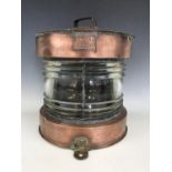 A ship's large copper Meteorite ship's masthead lantern, having a bisected clear fresnel lens, 35