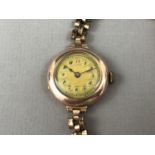 A 1920s lady's 9ct gold wristlet watch on rolled gold strap