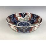 A Meiji Japanese Imari bowl, the decoration incorporating circular with depictions of cranes in