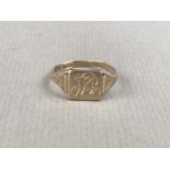 A 9ct gold signet ring, having a square face with engraved monogram, and foliate engraved shoulders,