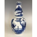 A late Qing Chinese blue-and-white double-gourd vase, decorated in depiction of figures in a