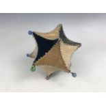 A Victorian patchwork star-shaped sampler pin cushion, of card construction, faced with swatches