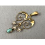 An Edwardian Secessionist turquoise and pearl pendant, in an openwork arrangement centred by pearl-