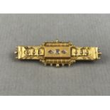 A Victorian Etruscan Revival diamond brooch, of tablet form, the raised rectangular face sunken