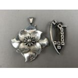 A Swedish white-metal pendant designed by Danish silversmith Hugo Grun, in the form of a flower-