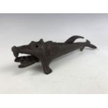 An early 20th Century novelty cast iron nut cracker modelled as a fish, bearing a registered