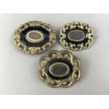 Three Victorian hairwork mourning brooches, each having a central glass locket surrounded by black