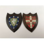 Two small late 19th / early 20th Century Cambridge College armorial plaques, bearing paper labels of